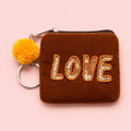 Brown velvet mini keyring purse with orange beaded and sequin ‘LOVE’ lettering, yellow pom pom and silver metal keyring.