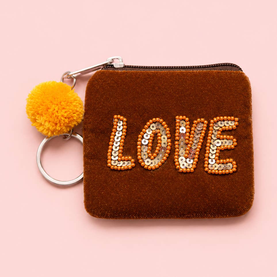 Brown velvet mini keyring purse with orange beaded and sequin ‘LOVE’ lettering, yellow pom pom and silver metal keyring.
