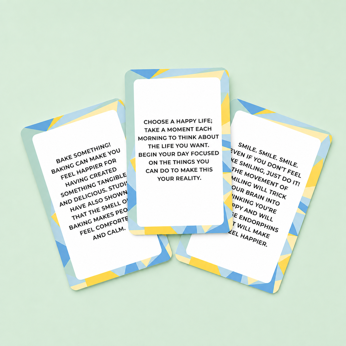 Three Be Happy activity and quote cards displayed on a soft mint green background.