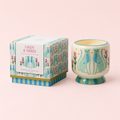 Linen and Orris soy wax candle in a colourful hand painted ceramic vessel with blue cheetahs and pink flowers, beside its matching box.