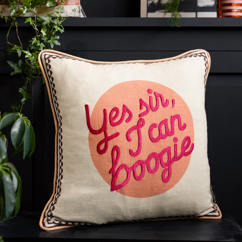 Cream 100% cotton cushion with pink embroidered Yes Sir, I Can Boogie lettering, peach circle and contrasting piping.