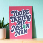 Colourful You’re Twisting My Melon Man A5 art print with bold navy retro lettering, a green melon detail and bright pink background.