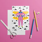 Colourful Birthday Wingwoman card featuring a woman in a pink flying suit with yellow plane wings, styled on a bright pink background.
