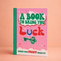 A Book to Bring You Luck colourful hardback gift book with bright pink and green cover, horseshoe and lucky key.