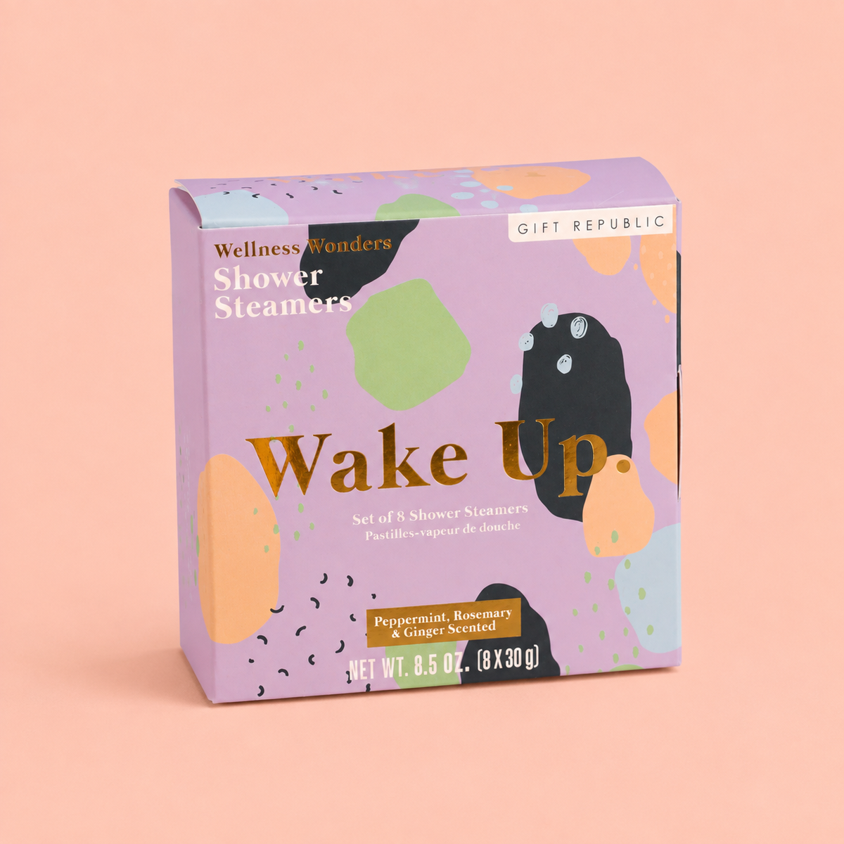 Box of eight Wake Up shower steamers scented with peppermint, rosemary and ginger in colourful lilac packaging on a peach background.