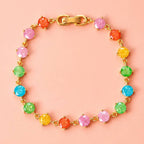 Rainbow frosted crystal bracelet with pink, orange, yellow, green and blue stones in a gold tone setting.