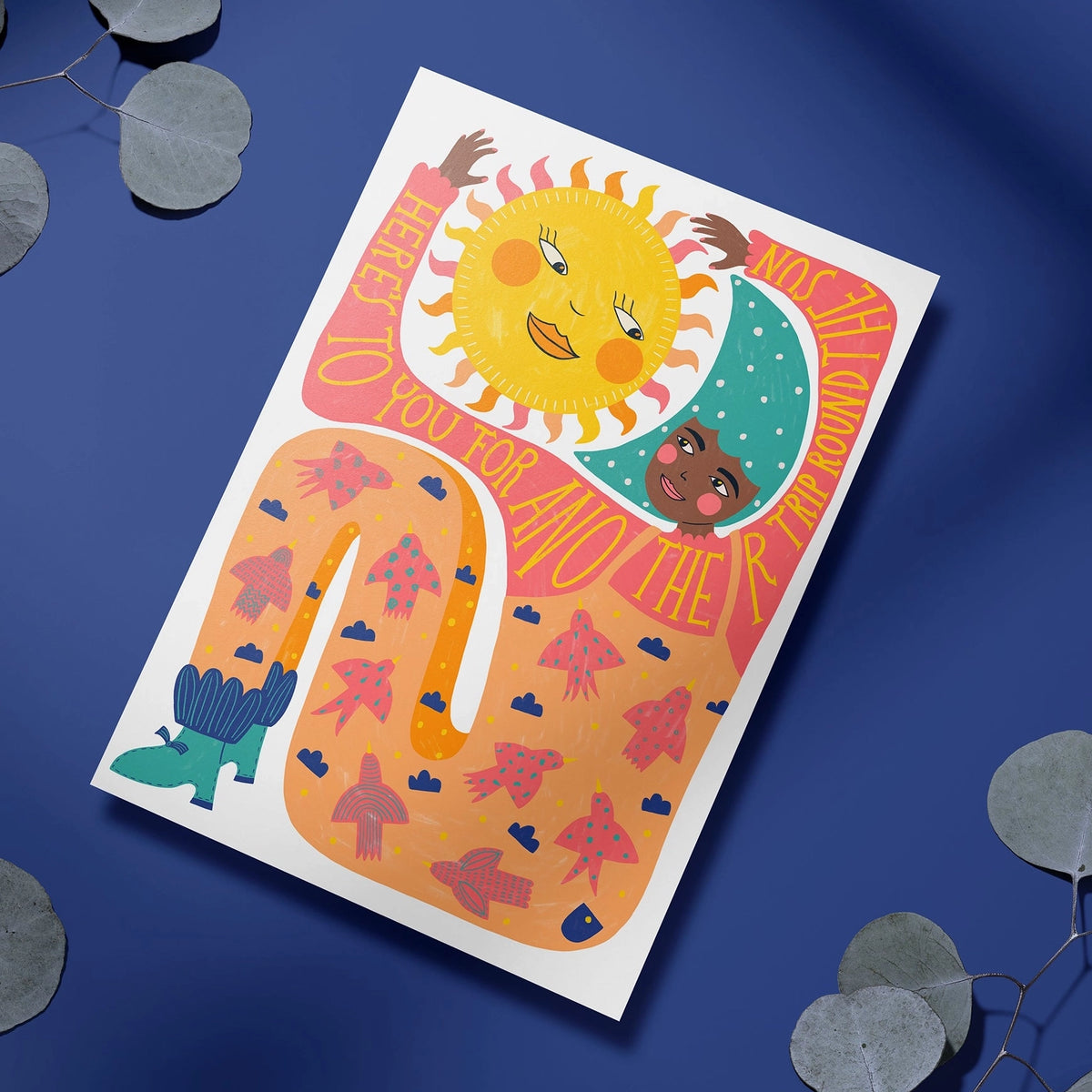 Colourful Another Trip Around The Sun birthday card featuring illustrated sun and moon characters on a bold orange, pink and blue design.