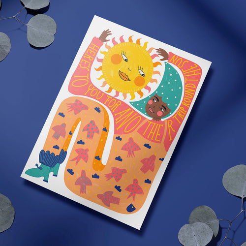 Colourful Another Trip Around The Sun birthday card featuring illustrated sun and moon characters on a bold orange, pink and blue design.