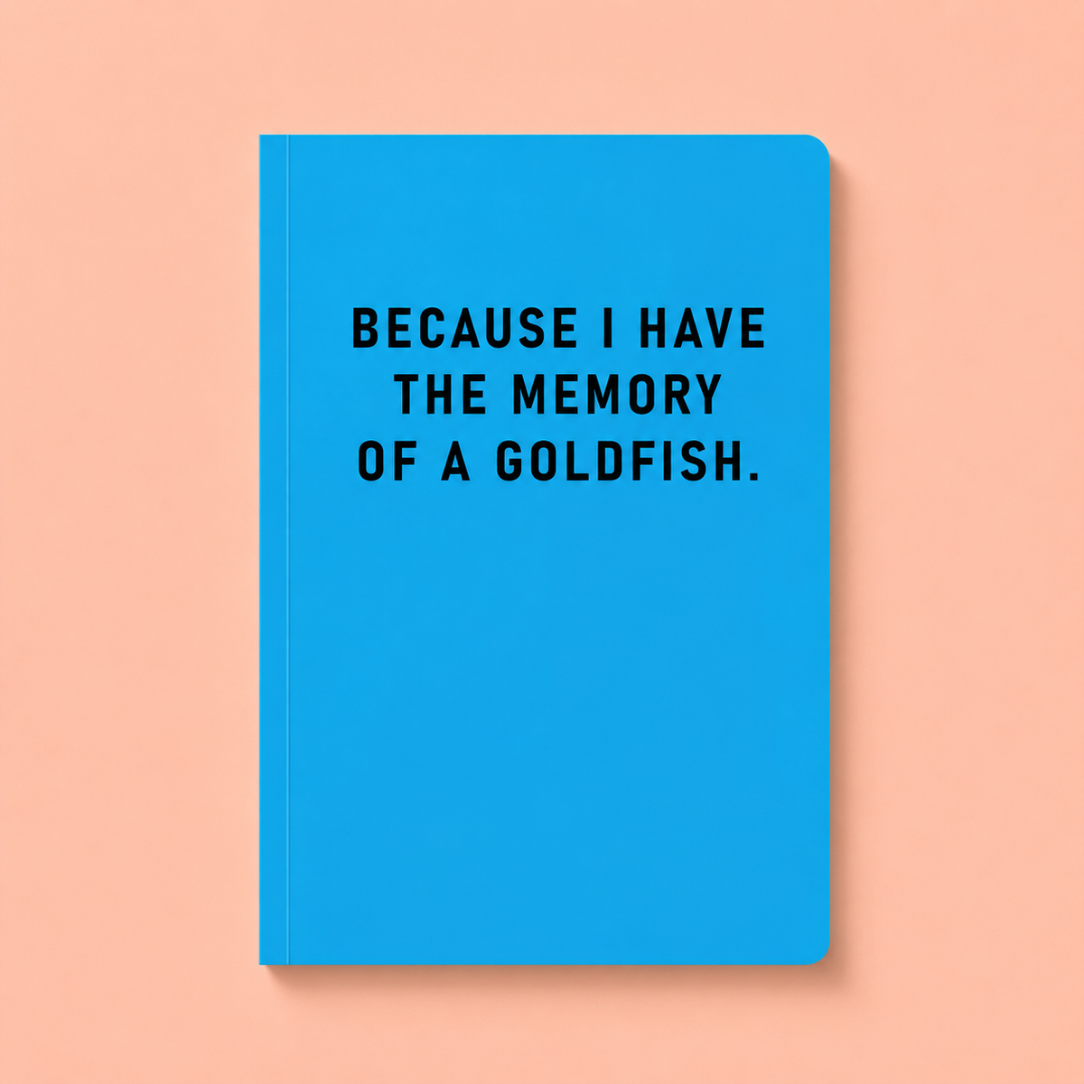 Bright blue A5 paperback notebook with black Because I Have The Memory Of A Goldfish text on a peach background.