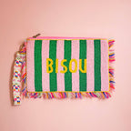 Pink and green striped beaded clutch bag with yellow Bisou lettering, colourful fringe and patterned wrist strap.