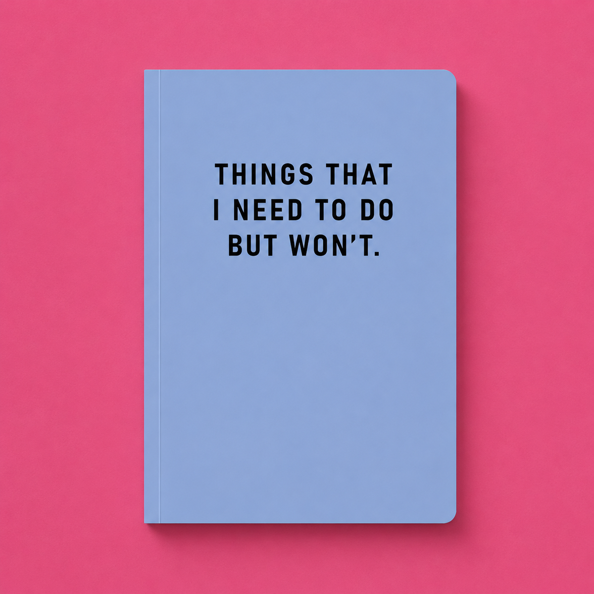 Pale blue A5 paperback notebook with black Things That I Need To Do But Won’t text on a bright pink background.