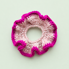 One of a kind crochet scrunchie handmade by Corrine in soft blush pink with a bright raspberry pink scalloped edge.
