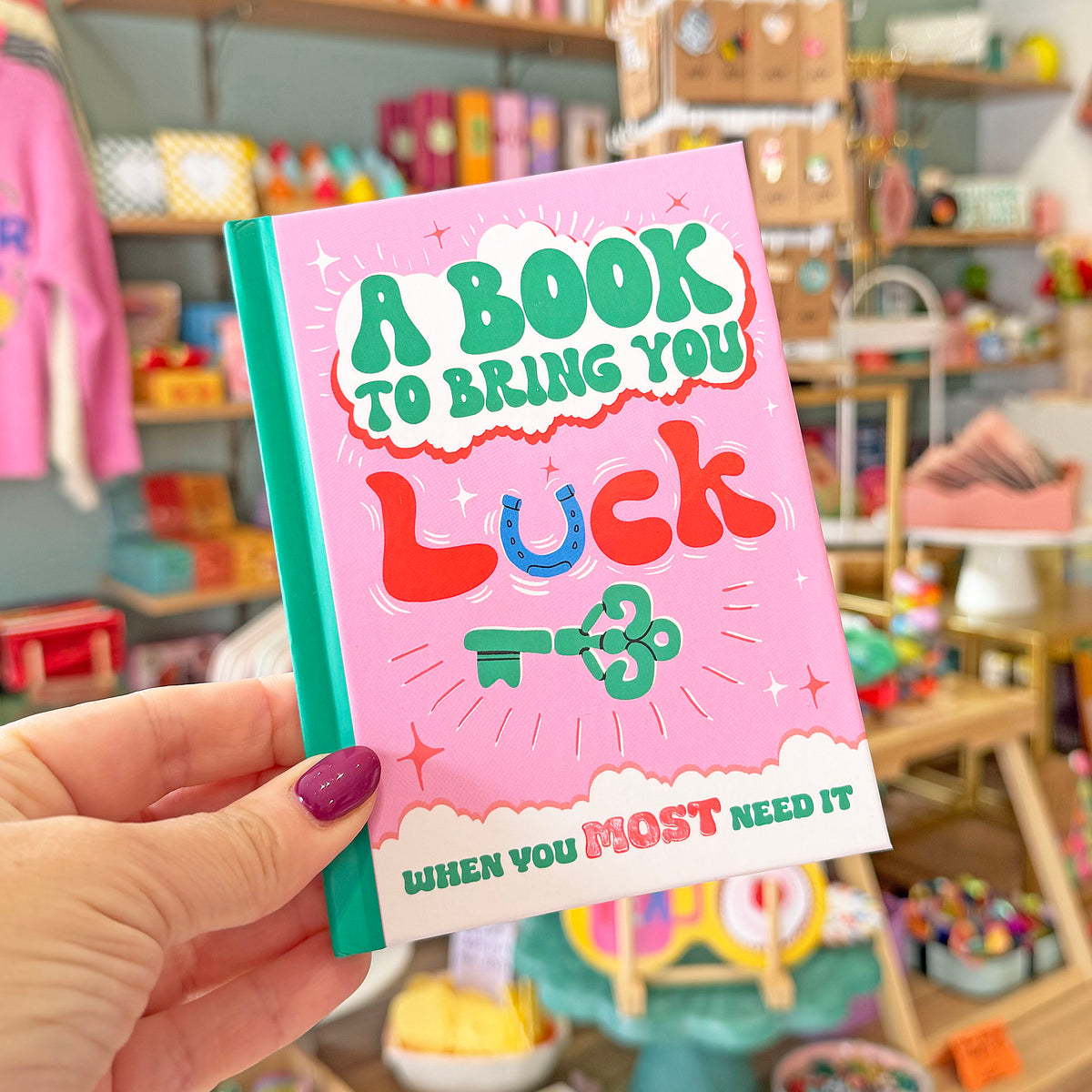 hand holding a little book to bring you luck