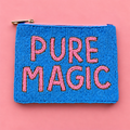 A rectangular blue beaded pouch with a gold zipper and the words 'PURE MAGIC' in pink beaded letters, displayed on a solid pink background.