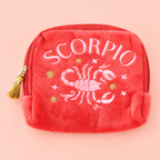 Red velvet Scorpio zodiac pouch with pink and gold embroidered scorpion, stars and gold tassel zip.