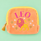 Peach orange Leo velvet pouch with bright pink and yellow lion embroidery on a soft green background.