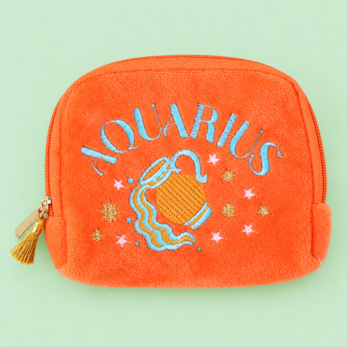 Bright orange velvet Aquarius zodiac pouch with blue, pink and gold water bearer embroidery and gold tassel zip.