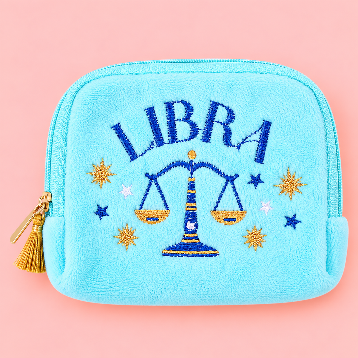 Aqua Libra velvet pouch with blue and gold scales embroidery on a soft pink background.