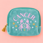 Teal Cancer velvet pouch with pink crab and colourful star embroidery on a soft pink background.