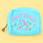 Turquoise velvet Sagittarius pouch with colourful embroidered stars, bow and arrow design and gold tassel zip on yellow background.