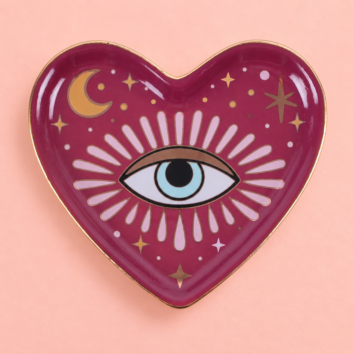 Heart shaped raspberry pink trinket dish with evil eye, moon, stars and gold detailing.
