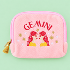 Pink Gemini velvet pouch with colourful embroidered twins and stars on a soft green background.