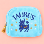 Turquoise Taurus velvet pouch with blue bull and colourful star embroidery on a soft pink background.