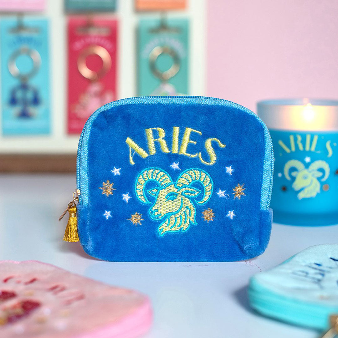 Blue Aries velvet zodiac pouch with colourful ram embroidery displayed alongside matching candle and colourful accessories.