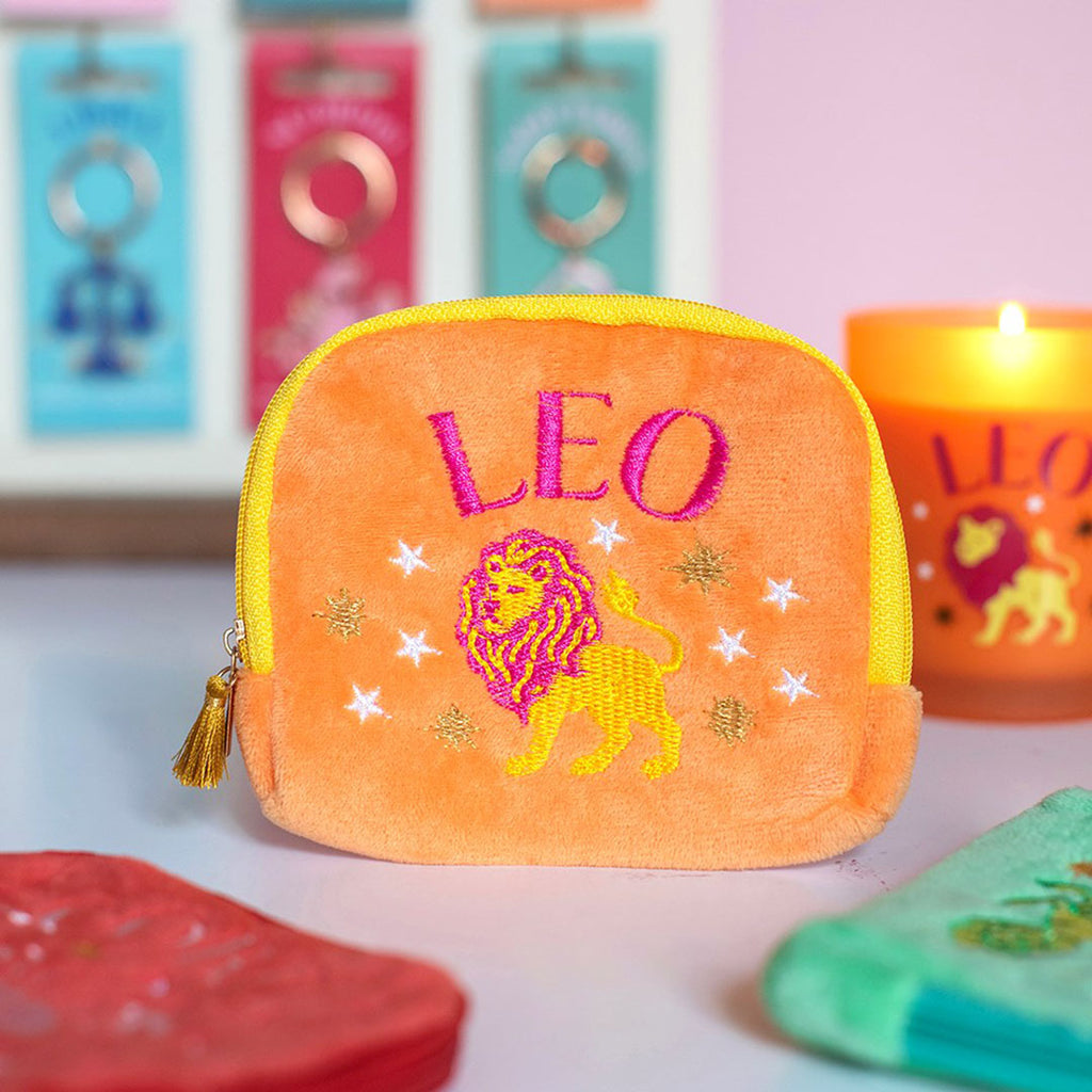 Peach orange velvet Leo zodiac pouch with hot pink and yellow embroidered lion, stars and gold tassel zip.