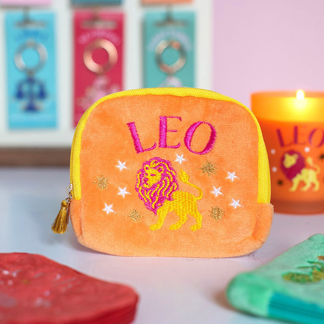 Peach orange velvet Leo zodiac pouch with hot pink and yellow embroidered lion, stars and gold tassel zip.