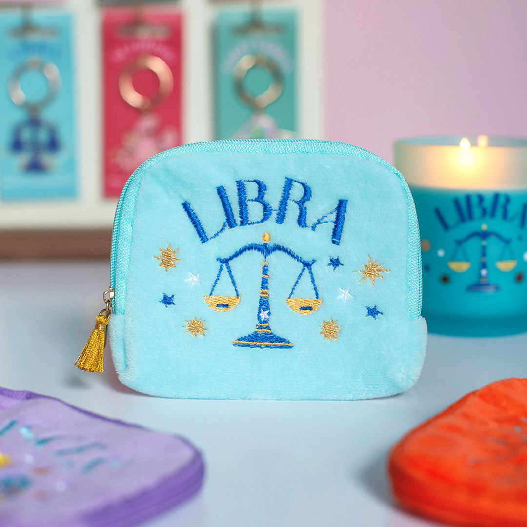 Aqua velvet Libra zodiac pouch with blue and gold embroidered scales, stars and gold tassel zip.