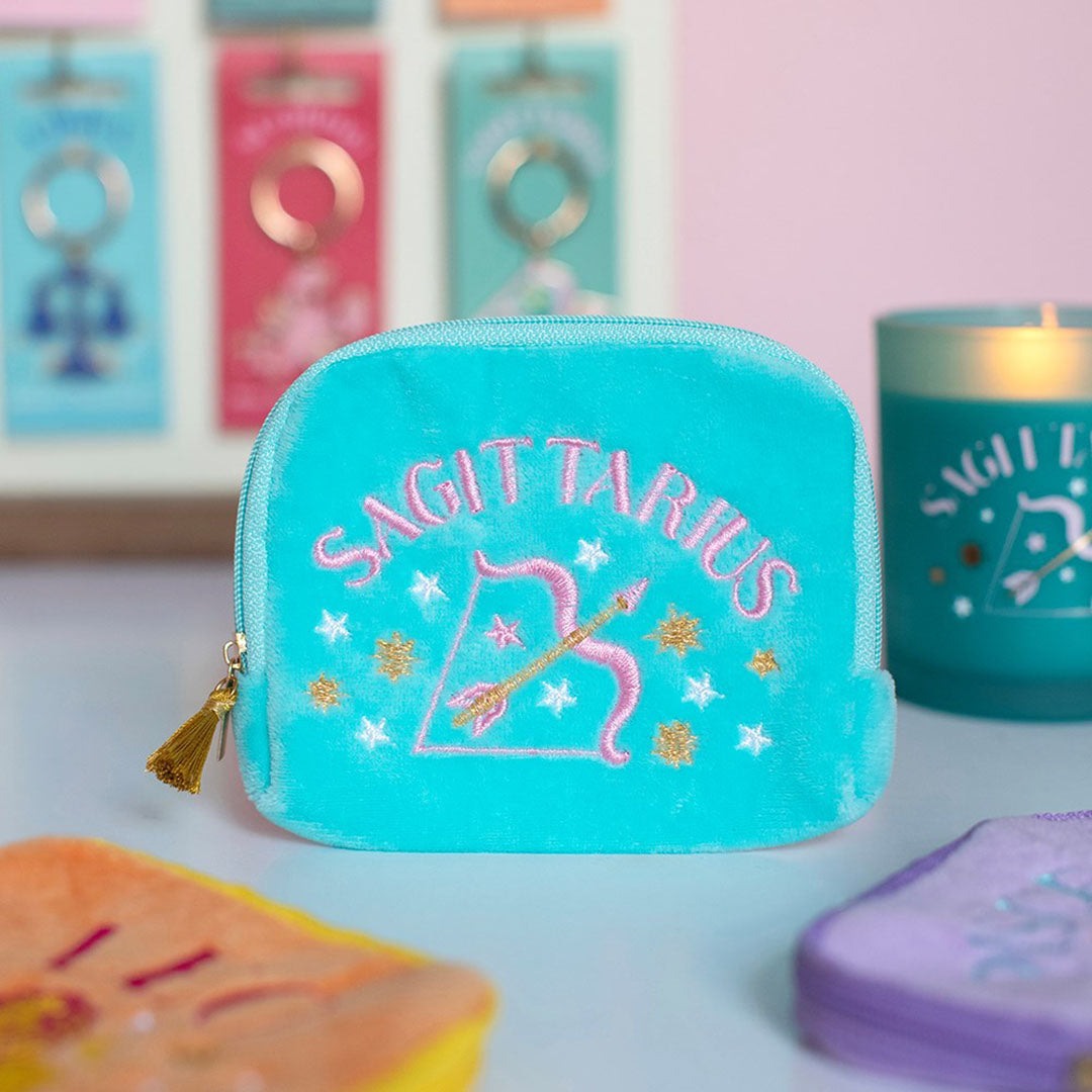 Turquoise velvet Sagittarius zodiac pouch with pink and gold bow and arrow embroidery and gold tassel zip.