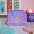 Lilac Pisces velvet pouch with colourful fish embroidery displayed alongside matching zodiac candle and accessories.