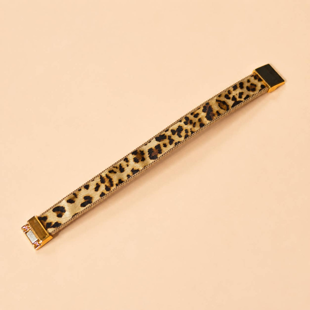 Leopard print bracelet laid flat showing the gold tone edging and magnetic fastening.