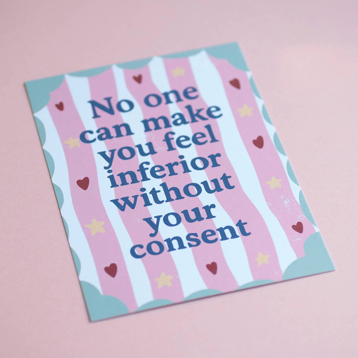 Joyful A5 quote print with bold blue lettering, wavy pink and white stripes, hearts and stars, photographed on a soft pink background.