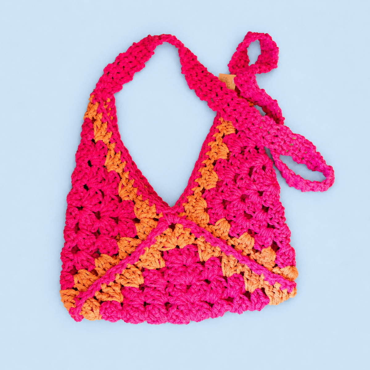 One of a kind heavyweight crochet shoulder bag handmade by Corrine in bright pink and orange macramé yarn.