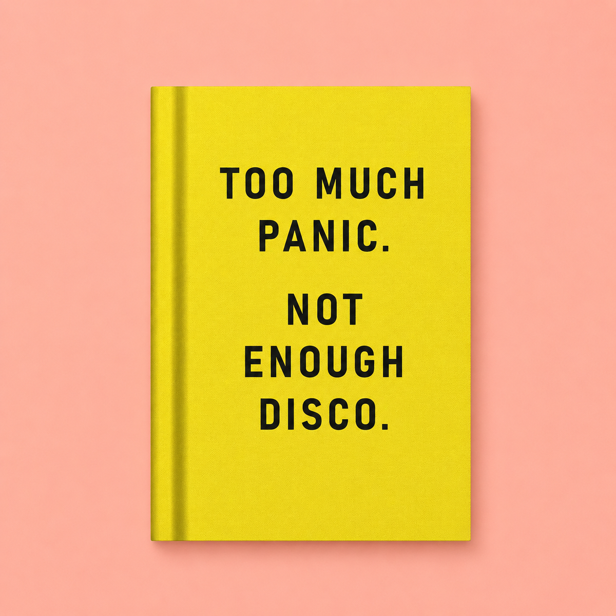 Bright yellow A7 fabric hardback notebook with black Too Much Panic Not Enough Disco text on a peach background.