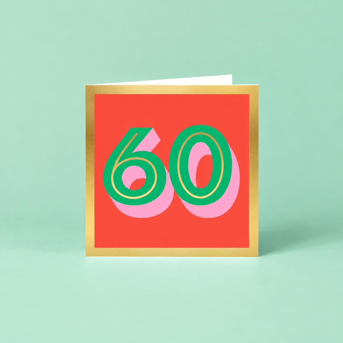 Colourful 60th birthday card with large green number 60, pink shadow detail, bright red background and metallic gold foil border.