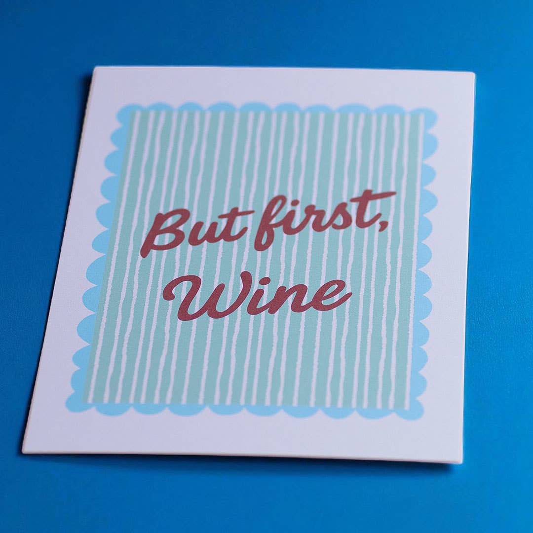 But First Wine A5 art print with red script and aqua striped design, photographed on a vivid blue background.