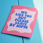 Playful We Like You But Please Leave By 10PM A5 print with retro blue lettering on a pink design.