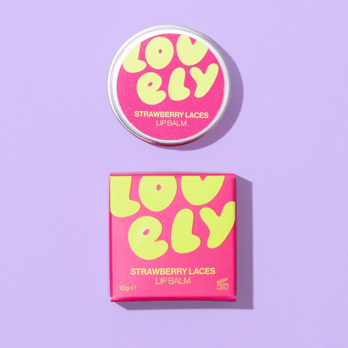 Strawberry Laces Lip Balm tin and colourful box displayed against a lilac tiled background.