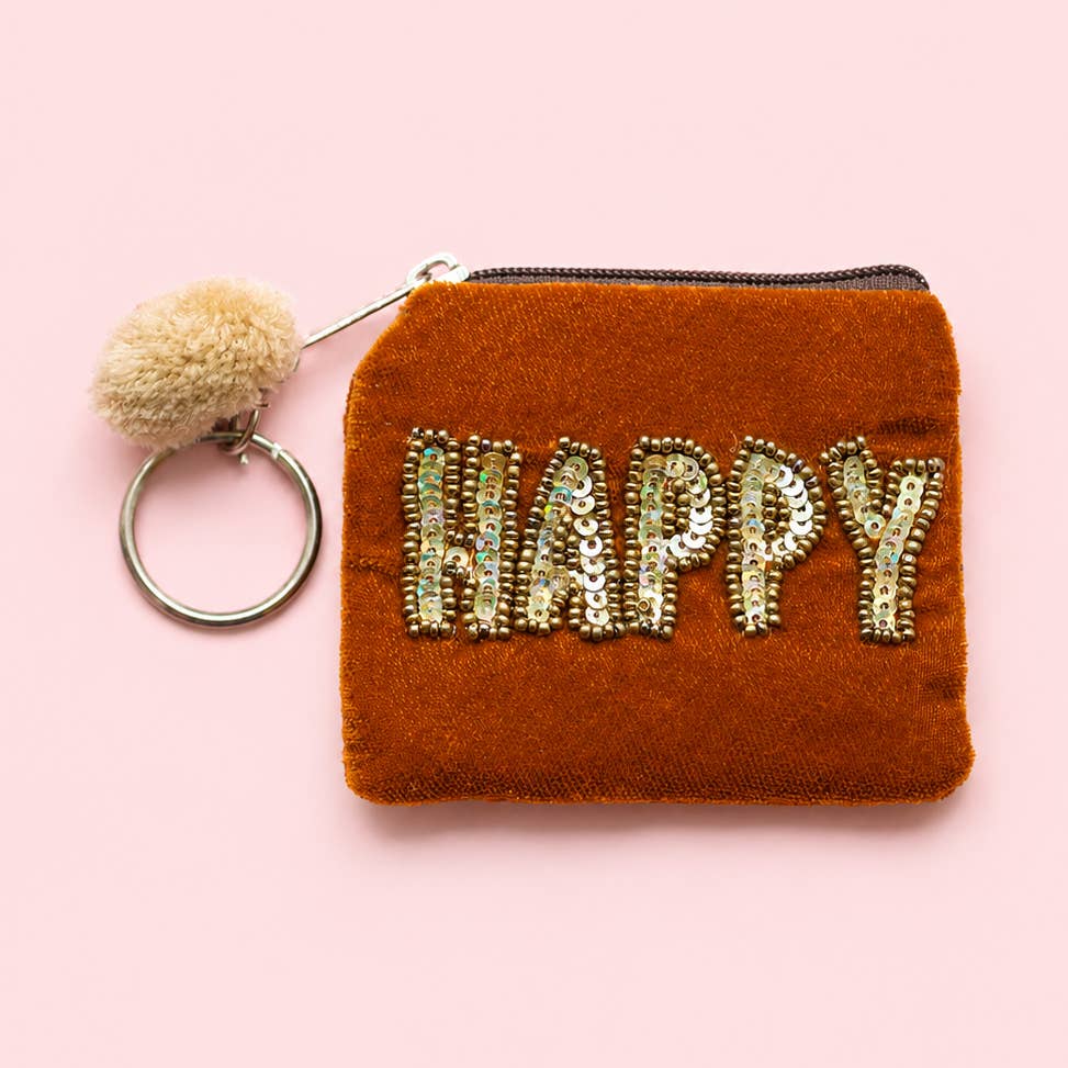 Orange velvet mini keyring purse with gold beaded and sequin ‘HAPPY’ lettering, cream pom pom and metal keyring.