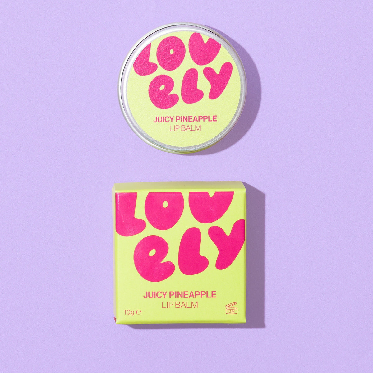 Grapefruit Lip Balm tin and colourful orange box displayed against a lilac tiled background.