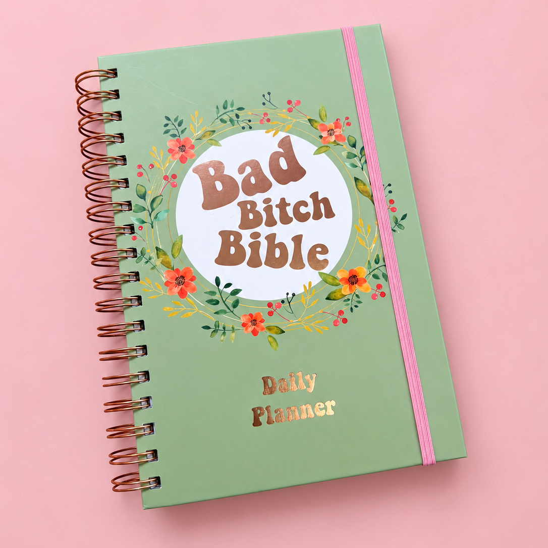 Sage green Bad Bitch Bible A5 daily planner with floral design, rose gold spiral binding and pink elastic closure.