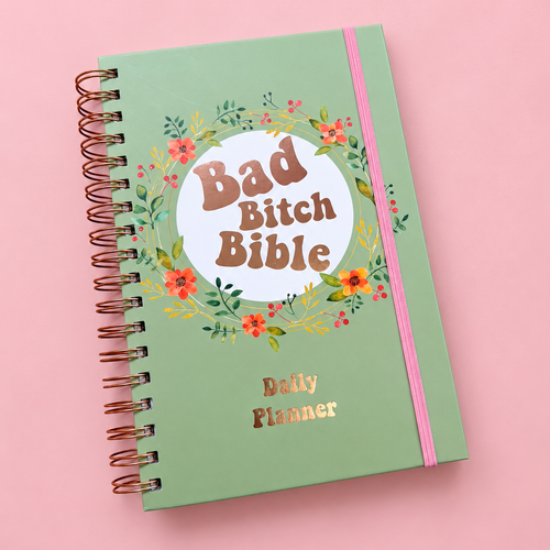 Sage green Bad Bitch Bible A5 daily planner with floral design, rose gold spiral binding and pink elastic closure.