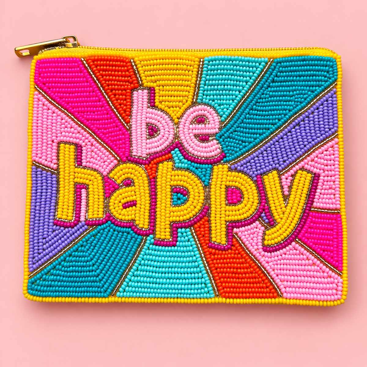 A square zippered pouch decorated with colorful beaded geometric panels and the words 'be happy' in raised lettering, shown on a solid pink background.