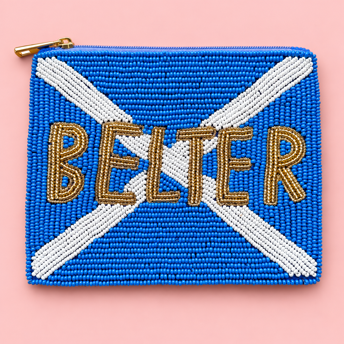 A rectangular beaded pouch featuring a blue and white Scottish saltire flag design with the word 'BELTER' spelled out in gold beads across the center, shown on a solid pink background.