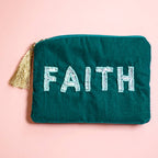 Teal velvet zip pouch with pale beaded ‘FAITH’ lettering and gold tassel detail.