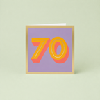 Colourful 70th birthday card with large orange number 70, coral shadow detail, soft lilac background and metallic gold foil border.