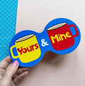 Bright blue Yours and Mine double coaster with illustrated yellow and red mugs and colourful retro lettering.
